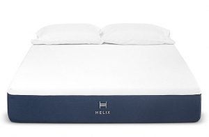 Helix mattress that has a purple bottom with it's logo in the middle of the bed