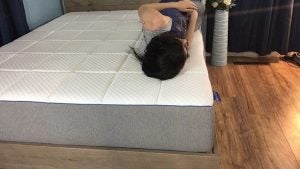 Jess lying on her side on the nectar mattress