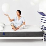 Picture of a woman on a bed sitting on a mattress with casper there