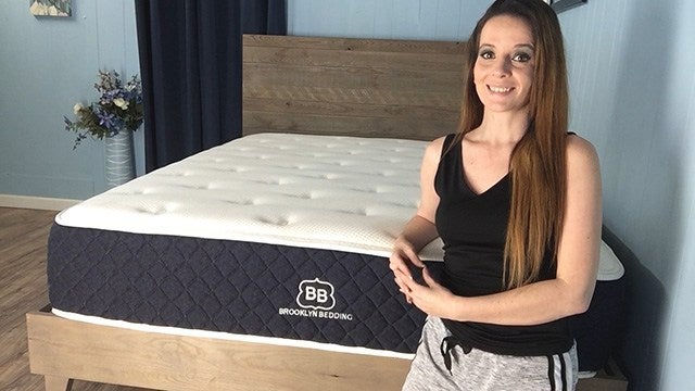 Female posing next to Brooklyn Bedding mattress