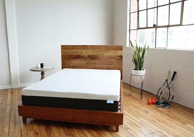 Image of a bear mattress in a well lit staged room with hardwood