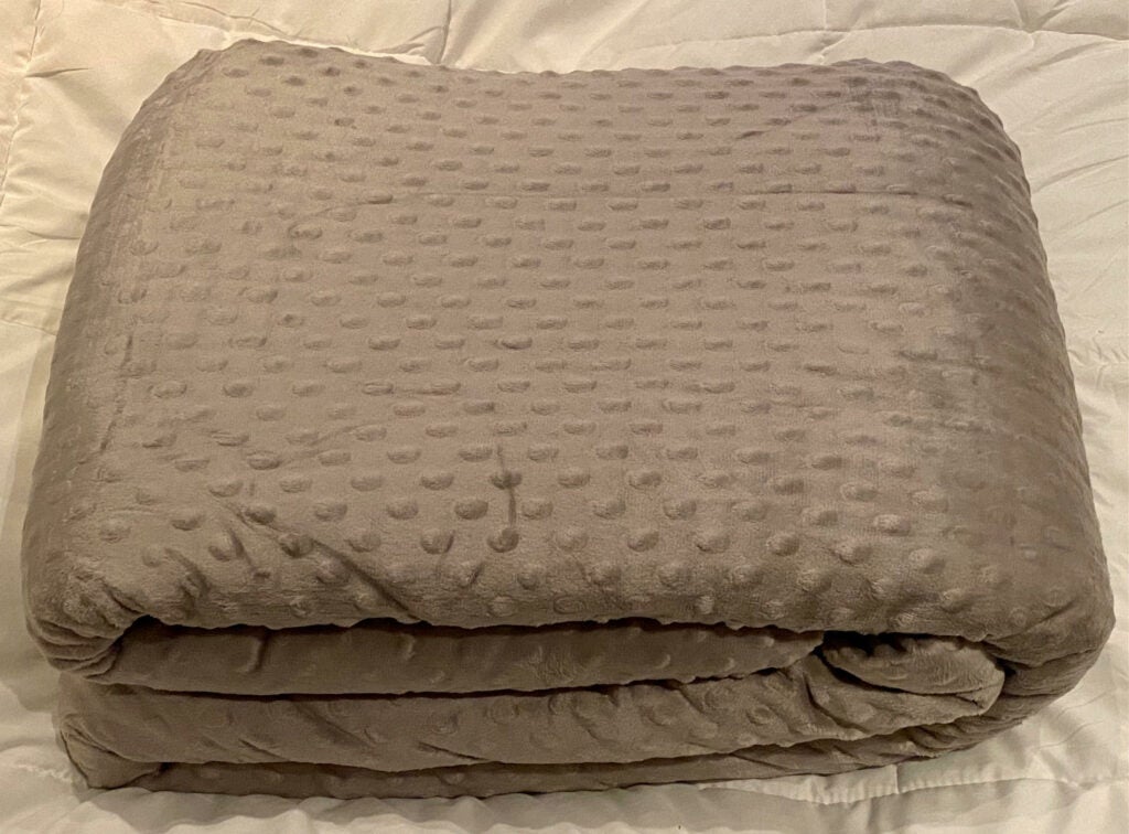 Quility weighted blanket folded on bed