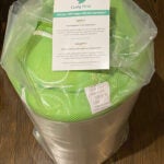 Green and white Cushy Form fold out mattress vacuum-sealed in original packaging
